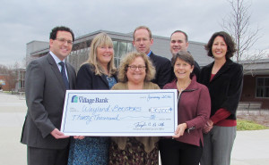 The bus stops here! Celebrating The Village Bank's recent $30,000 donation to the Wayland Boosters Association for a new student activities bus are, from left: (front) Susan Paley, the Bank's vice president of community relations, and Maureen Tillett, Wayland Boosters president; (rear) Joseph De Vito, Bank president and CEO; Patricia MacNeil, Bank vice president and Wayland branch manager; Mark Lucier, Boosters treasurer; Heath Rollins, Wayland athletic director; and Allyson Mizoguchi, Wayland High School principal.